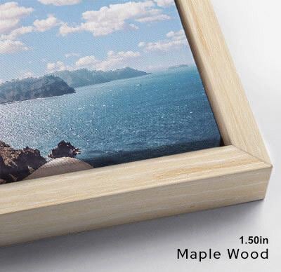 The image is a framed photograph of a scenic ocean view, with a wooden frame and a clear blue sky with clouds.