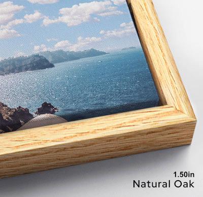 The image is a framed photograph of a scenic view of a body of water, likely the ocean, with mountains in the background. The photograph is framed in a natural oak wood frame, and the image is described as a "1.50in" size.