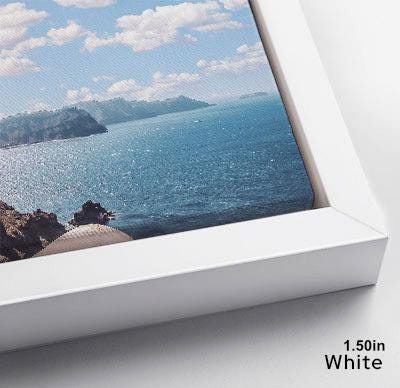 The image is a framed photograph of a scenic ocean view, with a rocky coastline and a clear blue sky in the background.