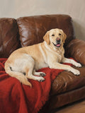 A golden retriever dog is comfortably lying on a brown leather couch, with its head resting on a red blanket.