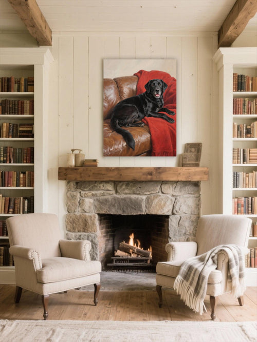 a cozy living room with a fireplace, two armchairs, and a large framed painting of a black dog on a red blanket hanging above the fireplace.