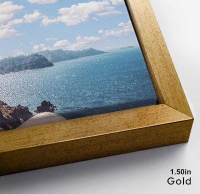 The image is a framed photograph of a scenic ocean view, with a rocky coastline and a clear blue sky in the background.